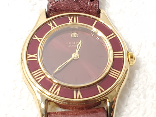 Vintage Seiko Gold Tone Women's Ruby Red Bezel Dial Watch Roman Numerals Leather