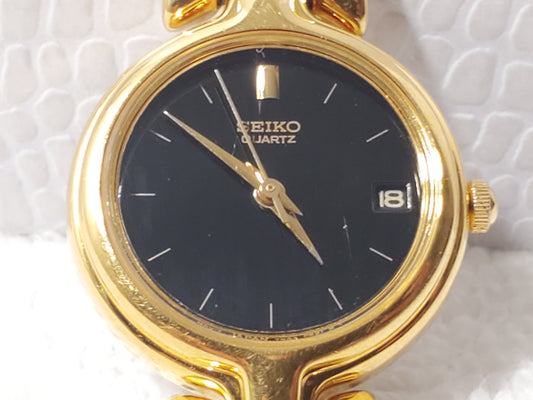 Vintage Seiko Women's Gold Tone Date Quartz Watch Black Dial Base Metal S Steel