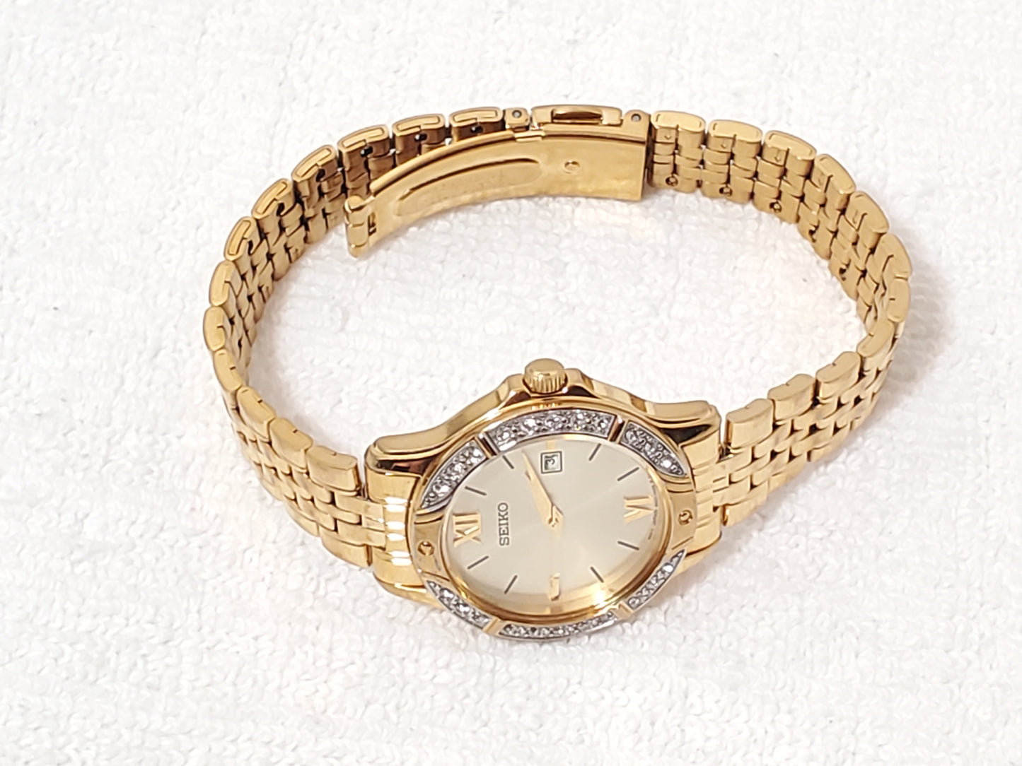 Seiko Women’s Date Quartz Watch Swarovski Crystal Gold Tone Roman Numerals